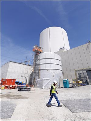 A FirstEnergy employee walks by the Emergency Feedwater Facility at Davis-Besse Nuclear Power Station in October of 2016.