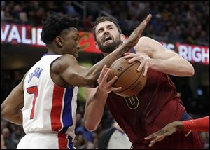 Detroit Pistons' Stanley Johnson, left, fouls Cleveland Cavaliers' Kevin Love in the first half of Sunday's game in Cleveland.