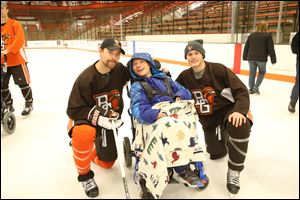 Bowling Green hockey player Mitch McLain, left, has invited students from the Wood Lane School to take the ice with the Falcons.