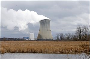 Plumes of steam drift from the cooling tower of FirstEnergy Corp.'s Davis-Besse Nuclear Power Station in Oak Harbor, Ohio.