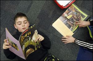 Curtis Cook, 10, reads aloud as he and other fourth-grade students learn about Rosa Parks Thursday at Fort Meigs Elementary School in Perrysburg.