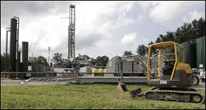 This Aug. 13, 2013, file photo shows a gas drilling rig at the Detweiler well in Salesville, Ohio. 
