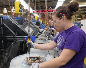 Kaitlyn Bollinger works on the assembly line building washing machines at Whirlpool in Clyde Ohio.