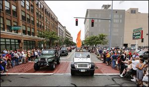 Spectators watch a parade of Jeeps in Toledo during Jeep Fest in August of 2016. 