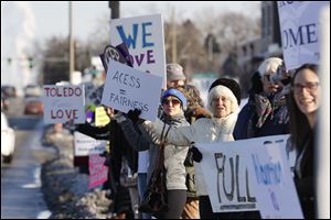 Protesters gathered near ProMedica Toledo Hospital to call on ProMedica and St. Luke’s Hospital to sign a transfer agreement with Capital Care Network.