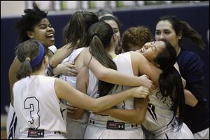 Maumee Valley Country Day's Maya Francisco, right, is embraced by her teammates after the Hawks won a share of the Toledo Area Athletic Conference championship with Thursday's win over Danbury.