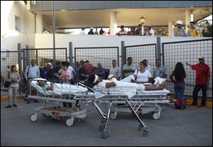 Patients rest in their hospital beds parked outside the General Hospital after they were evacuated, in Veracruz, Mexico, Friday, Feb. 16, 2018. A powerful magnitude-7.2 earthquake shook south and central Mexico Friday.