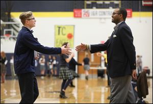 A.J. Austin, 13, shakes hands with judge John C. Jones during the Great Shake competition at Toledo Christian Friday, February 16, 2018.  Students were evaluated on things such as their hand shakes, poise, and discussion skills as they circulated through a variety of judges.