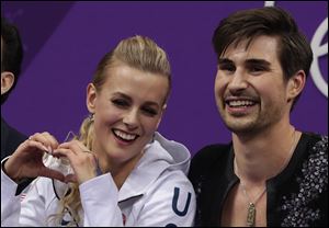 Madison Hubbell and Zachary Donohue of the United States react as their points are posted following their performance in the ice dance, short dance program at the 2018 Winter Olympics.