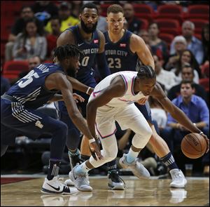 Miami Heat guard Josh Richardson, center, regains control of the ball in front of Reggie Bullock (25), Andre Drummond and Blake Griffin of the Detroit Pistons.