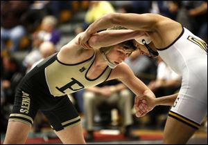 Perrysburg's Alex Garee, left, and Olmsted Falls' Jihad Salti wrestle at 138 pounds during the finals of the district wrestling tournament at Perrysburg High School.