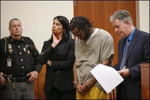 Brian Lee Golsby, center, stands with his attorneys Diane Menashe, second from left, and Kort Gatterdam, right, as Franklin County Prosecutor Ron O'Brien, not pictured, reads six of 18 counts against him during his arraignment hearing on April 3, 2017, at Franklin County Common Pleas Courthouse in Columbus.