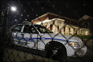 Huffman High School is seen behind a Birmingham Police car after a shooting Wednesday, March 7, 2018, in Birmingham, Ala. 