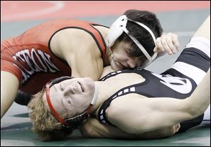 Wauseon’s Hunter Yackee, top, scores back points on St. Paris Graham’s Isiah Stickley during their 132-pound match in a Division II first-round bout at the state tournament.
