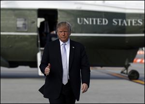 President Donald Trump walks to board Air Force One at Los Angeles International airport.