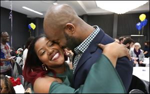 Latima Collis of Detroit, a fourth-year medical student at the University of Toledo, left, celebrates with new fiance Andrew Anamanya of Washington DC,  after getting engaged and learning her residency placement.