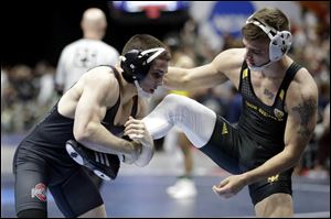Ohio State's Nathan Tomasello, left, controls Arizona State's Ryan Millhof during a 125-pound weight class match at the NCAA Division I Wrestling Championships in Cleveland. 