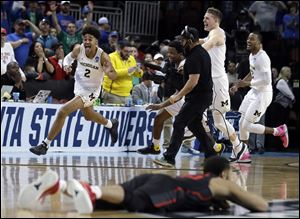 Michigan guard Jordan Poole celebrates his game-winning basket in a second round NCAA Tournament game against Houston.