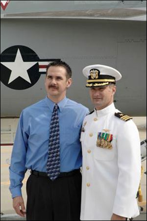 Left Chad Albert, of Toledo, with his cousin, Cmdr. David Fravor, in an October, 2004, file photo when Commander Fravor took command of VFA-41, Strike Fighter Squadron 41 also known as the 