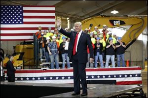 President Donald Trump waves as he is introduced to speak at Local 18 Richfield Training Facility, Thursday, March 29, 2018, in Richfield.