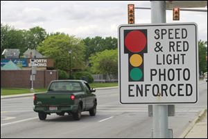 A red light speed camera sits near the intersection of Cherry Street and East Delaware Avenue in Toledo.