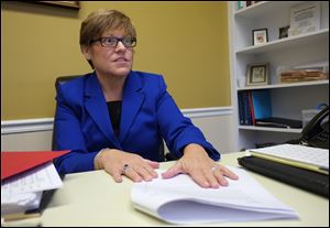 Mary Smith, owner of  Smith Bonds & Surety, talks about a bill designed to reform the state's bail system during an interview in her office Wednesday, April 4, 2018, in Toledo.  