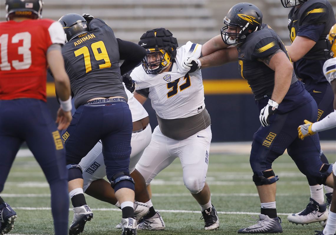 Rossford graduate Nate Childress (93) fights offensive linemen during the University of Toledo football spring game on April 13 at the Glass Bowl.