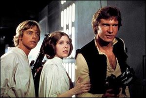 This photo provided by Twentieth Century Fox Home Entertainment shows, Mark Hamill, from left, as Luke Skywalker, Carrie Fisher as Princess Leia Organa, and Harrison Ford as Hans Solo in the original 1977 