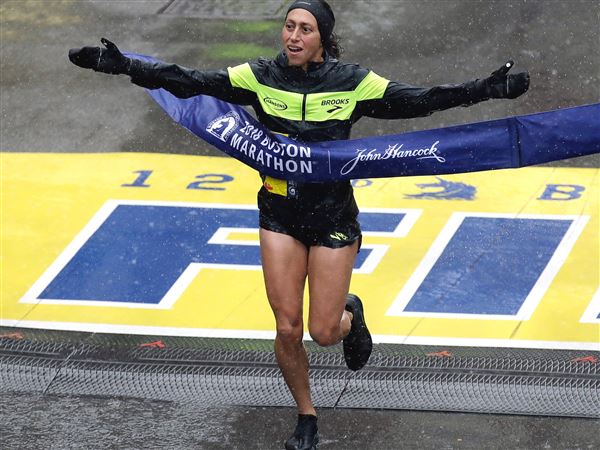 Local runners starting to cross Boston Marathon finish line