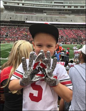 Tre Martinez shows off his new Ohio State gloves, which were given to him by Buckeyes wide receiver Terry McLaurin.