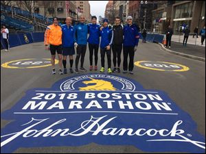Herman Burmeister (far left), Tim Oser (third from right), and Tim Corbey (second from right) are running three marathons in the span of 13 days.
