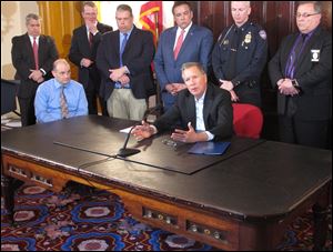 Gov. John Kasich discusses the need to improve the speed and accuracy of the reporting of information about individuals prohibited under law from having a gun to a national background check database.