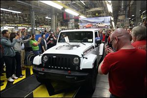 Workers applaud as JK Assembly Center Manager James Gholston Jr. drives the final Jeep Wrangler JK off the line at 3:36 p.m. Friday at the Toledo Assembly Complex. More than 2.1 million JK Wranglers were produced during the 12-year-long production run, which began in 2006. The final Wrangler JK was a 2018 Jeep Wrangler Rubicon Unlimited. 