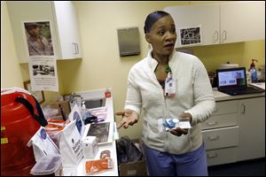 Nurse Lisa Hawthorne-Price discusses the services she provides for clients Thursday, March 29, 2018, at the Northwest Ohio Syringe Services mobile exchange located at the Talbot Center in East Toledo.