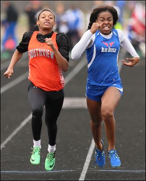 Victoria Abunaw of Springfield, right, edges Charnae Merrell of Sylvania Southview in the girls 100 meter dash during Northern Lakes League championships at Bowling Green High School.