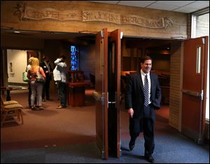 Arizona Gov. Doug Ducey walks out of the Chapel of St. John Berchmans after speaking and answering questions Thursday. Ducey was a student at St. John's.