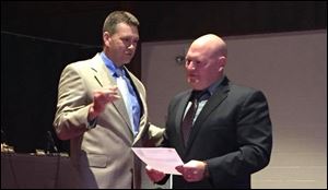 Northwood police officer Kenneth Campbell, right, being sworn in as chief of Walbridge police. 