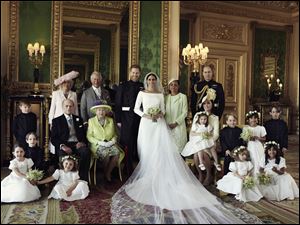 Britain’s Prince Harry and Meghan Markle pose alongside the other members of their wedding party on Saturday, May 19.