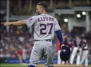 Houston Astros' Jose Altuve celebrates after hitting a two-run double off Cleveland Indians relief pitcher Andrew Miller.