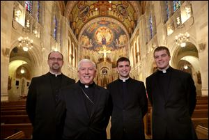 Kyle Gase, left, Bishop Daniel E. Thomas, Scott Perry and Andrew Wellmann, in Rosary Cathedral.