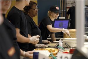 Haylee Bobak, right, takes orders and helps serve food during the grand opening of the newest Tony Packo's Restaurant.