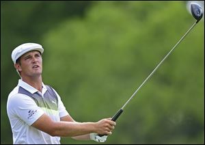 Bryson DeChambeau follows his tee shot on the 18th hole during the third round of the Memorial golf tournament in Dublin, Ohio. 