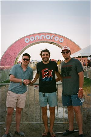 Oliver Hazard — from left, Griffin McCulloch, Mike Belazis, and Devin East — in front of the Bonnaroo sign at the festival.