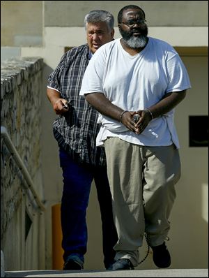 Anthony Haynes is escorted out of the U.S. District Court in Toledo in July.