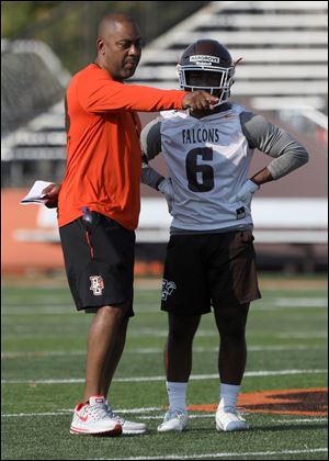Bowling Green head coach Mike Jinks gives instruction to running back Ra'veion Hargrove during opening day of practice Friday.