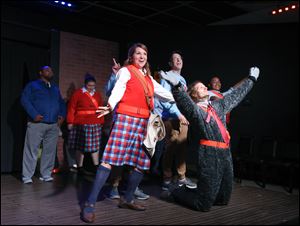 Amy Carpenter, left, Paul Heuring, and David Bensch, as Sparky the Labradoodle, in a scene from the play.