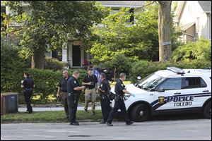 In this file photo, Toledo police investigate a shooting on August 14 in the 2800 block of Broadway, across from Walbridge Park, in Toledo.