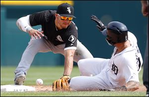 Chicago White Sox's Yolmer Sanchez can't handle the throw at second base as Detroit Tigers' Nicholas Castellanos slides safely.