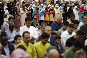 Men, women and children pray as area mosques celebrate last year’s Eid al-Adha at the SeaGate Convention Centre. The annual gathering for prayers will be at 9:45 a.m. Tuesday. 