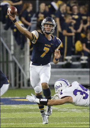 Whitmer High School quarterback Riley Keller throws as he's pressured by Fremont Ross High School player Caleb Wood in 2017.